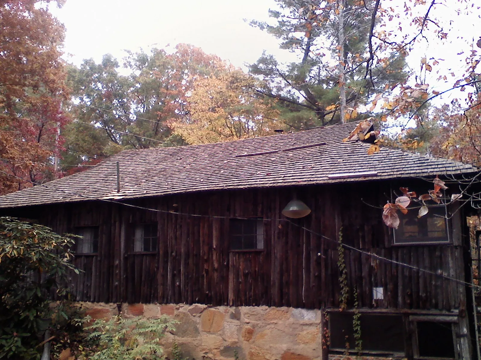 Weathered wood shake roof on a rustic board sided cabin in Wellersburg